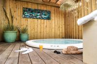 a jacuzzi tub sitting on a wooden deck at The Originals Boutique La Villa Ouest &amp; Spa in Saint-Palais-sur-Mer