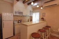 a kitchen with a counter and a refrigerator and stools at Beautiful Life B&amp;B in Dongshan