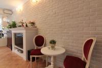 a room with a white brick wall and a table and chairs at Beautiful Life B&amp;B in Dongshan