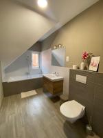 a bathroom with a toilet and a sink and a tub at FENYŐ APARTMAN House I in Odorheiu Secuiesc
