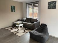 a living room with a couch and a table at FENYŐ APARTMAN House I in Odorheiu Secuiesc