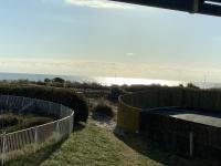 a view of a fence with the ocean in the background at APPARTEMENT VUE OCEAN ET PISCINE in Lacanau