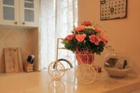 a vase of flowers on a counter with a vase of flowers at Beautiful Life B&amp;B in Dongshan