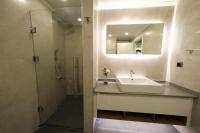 a bathroom with a sink and a shower and a mirror at Sky Garden Suites in Adana