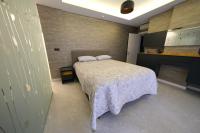 a bedroom with a bed with two pillows on it at Sky Garden Suites in Adana