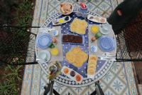a table with breakfast foods on a blue and white plate at Riad Catalina in Marrakech