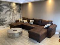 a living room with a brown leather couch and a coffee table at Nouveau !! Bel appartement à Fécamp tout près de la plage, gare et voie verte in Fécamp