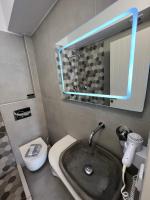 a bathroom with a sink and a toilet and a mirror at George Studios in Naxos Chora
