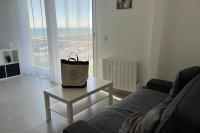 a purse sitting on a table in a living room at Les Pieds dans le Sable in Le Grau-du-Roi