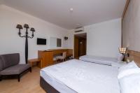 a bedroom with a bed and a chair and a desk at Lake River Side Hotel Spa in Side