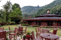 a group of tables and chairs in front of a building at Fish Tail Lodge in Pokhara