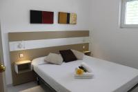 A bed or beds in a room at Agi Residencial Almadraba