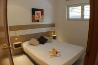 A bed or beds in a room at Agi Residencial Almadraba