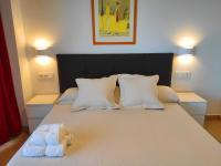 A bed or beds in a room at BEACHFRONT -- NEW LUXURY Apartment -- 1ª Linea Playa -- Fuengirola CITY CENTER -- Private PARKING -- Panoramic Sea Views --