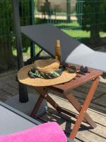 a straw hat sitting on a wooden table at Résidence Les Sources in Saint-Rémy-de-Provence