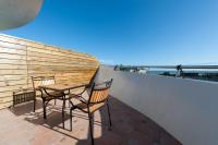 a patio with two chairs and a table on a balcony at Discovery B&amp;B in Linbian