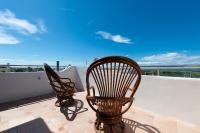 two chairs on a balcony with a view of the ocean at Discovery B&amp;B in Linbian