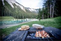 a grill with meat and bread and food on it at Ecrin Blanc Resort Courchevel in Courchevel