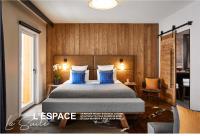 a bedroom with a large bed with blue pillows at Ecrin Blanc Resort Courchevel in Courchevel