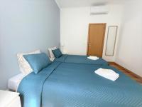 Postel nebo postele na pokoji v ubytování Lisboa Sweet Family Homestay