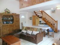 a living room with a couch and a table at Granite stone house with fireplace, Plouguerneau in Plouguerneau