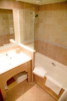 a bathroom with a tub and a sink and a shower at Les Alpages De Val Cenis by Resid&amp;co in Lanslebourg-Mont-Cenis