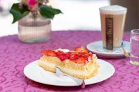 a piece of cake on a plate on a table at Gesundhotel Bad Reuthe in Vorderreuthe