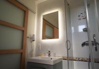 a bathroom with a sink and a shower with a mirror at Hotel et Studios Le Marina Baie de La Baule in Pornichet