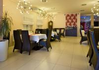 a dining room with black chairs and a white table at Parkhotel Plzen Congress Center in Plzeň