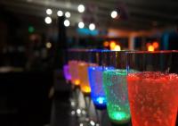 a row of colorful glasses sitting on a bar at Hotel et Studios Le Marina Baie de La Baule in Pornichet
