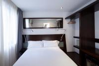 A bed or beds in a room at Petit Palace Arana Bilbao