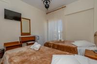 Postel nebo postele na pokoji v ubytování Hotel Alkyon