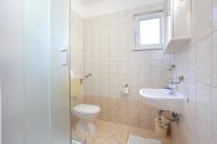 a bathroom with a toilet and a sink at Apartments Lias - with restaurant in Rogoznica