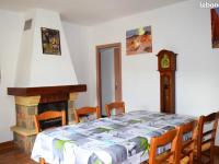 a dining room with a table and a grandfather clock at Maison de 5 chambres avec jardin amenage a Les Vans in Les Vans