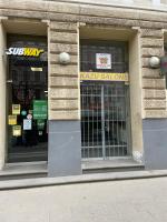 a store front with a window with a sign on it at Orange Cat Rooms in Riga