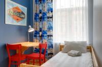 a bedroom with a bed and a table and chairs at Orange Cat Rooms in Riga