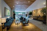 a lobby with couches and chairs and a bar at Silverland Yen Hotel in Ho Chi Minh City