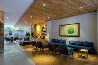 a lobby with a blue couch and a table and chairs at Silverland Yen Hotel in Ho Chi Minh City