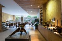 a restaurant with wooden walls and tables and chairs at Silverland Yen Hotel in Ho Chi Minh City