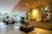 a living room with a table and a dining room at Silverland Yen Hotel in Ho Chi Minh City