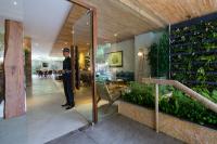 a man in uniform standing in a room with plants at Silverland Yen Hotel in Ho Chi Minh City