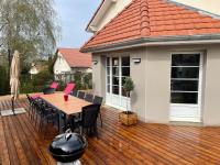 a wooden deck with a table and chairs on a house at Le boudoir in Épinal