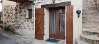 a wooden door on the side of a building at La maison du pêcheur in Livinhac-le-Haut