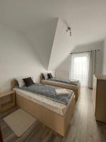 a bedroom with two beds and a window at FENYŐ APARTMAN HOUSE II. in Odorheiu Secuiesc
