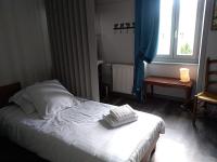 a bedroom with a bed and a window at Logis Le Relais de Thézillieu in Thézillieu