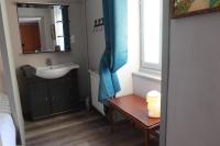 a small bathroom with a sink and a mirror at Logis Le Relais de Thézillieu in Thézillieu