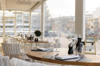 a restaurant with tables and chairs with wine glasses at Hotel Indigo Cagnes-sur-Mer by IHG in Cagnes-sur-Mer