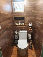 a bathroom with a toilet and wooden walls at &#39;T boshuisje in Opglabbeek