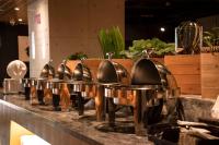 a row of copper kitchen faucets on a counter at Hub Hotel Kaohsiung Yawan Branch in Kaohsiung
