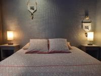 a bedroom with a bed with two lamps on two tables at Résidence Royal Palmeraie in Aubagne